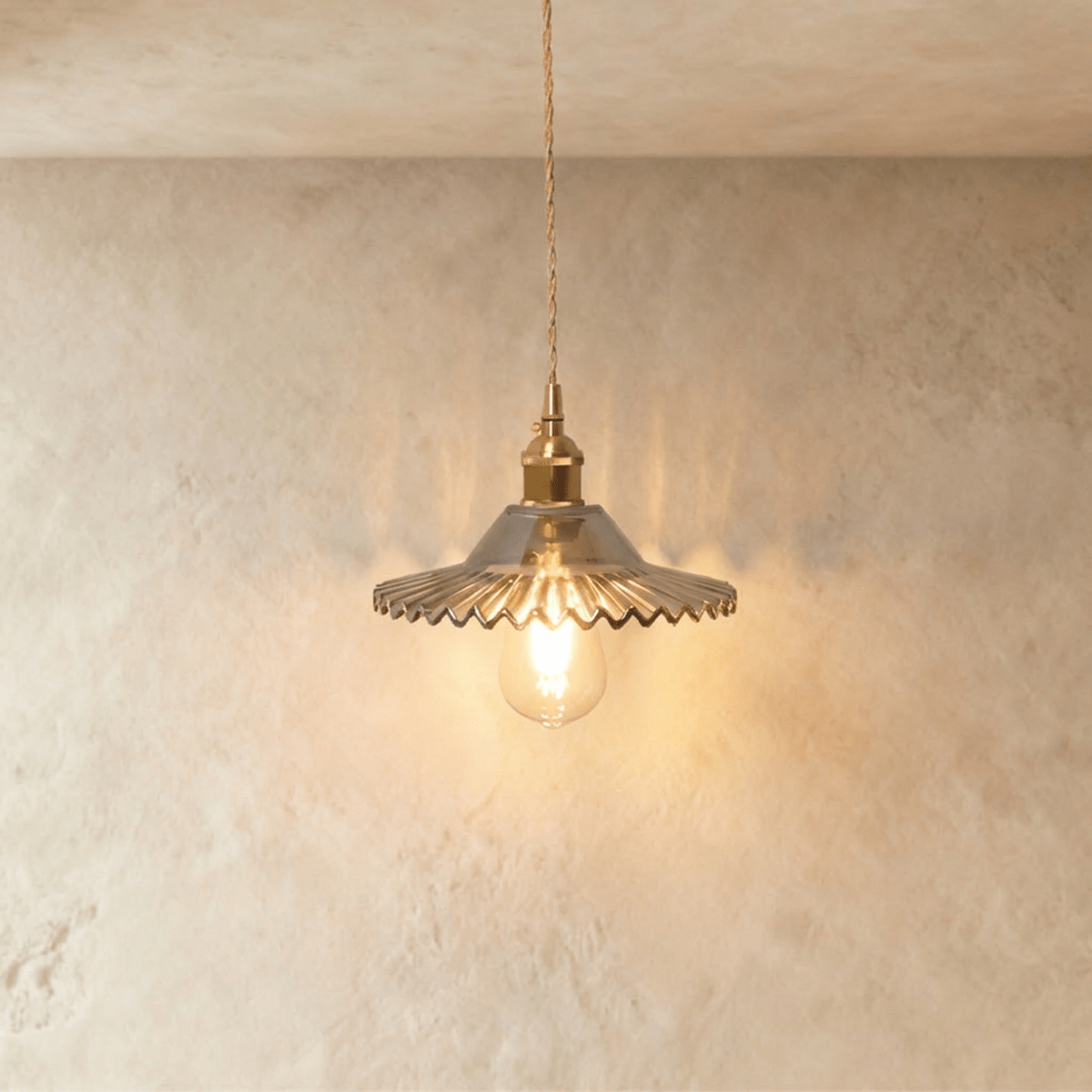 Residence Supply Isabel pendant light hanging from ceiling with a sleek modern design and a warm ambient glow.