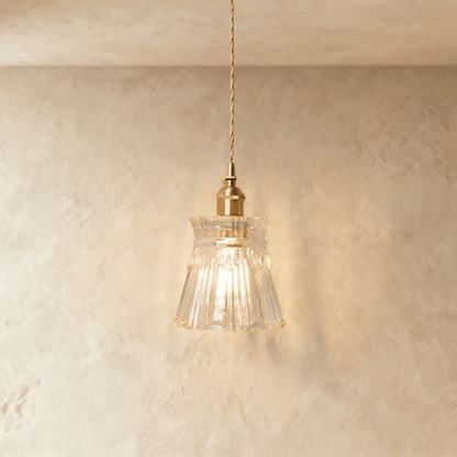 Residence Supply Isabel pendant light with a sleek metal fixture and glass shade, hanging from a ceiling.