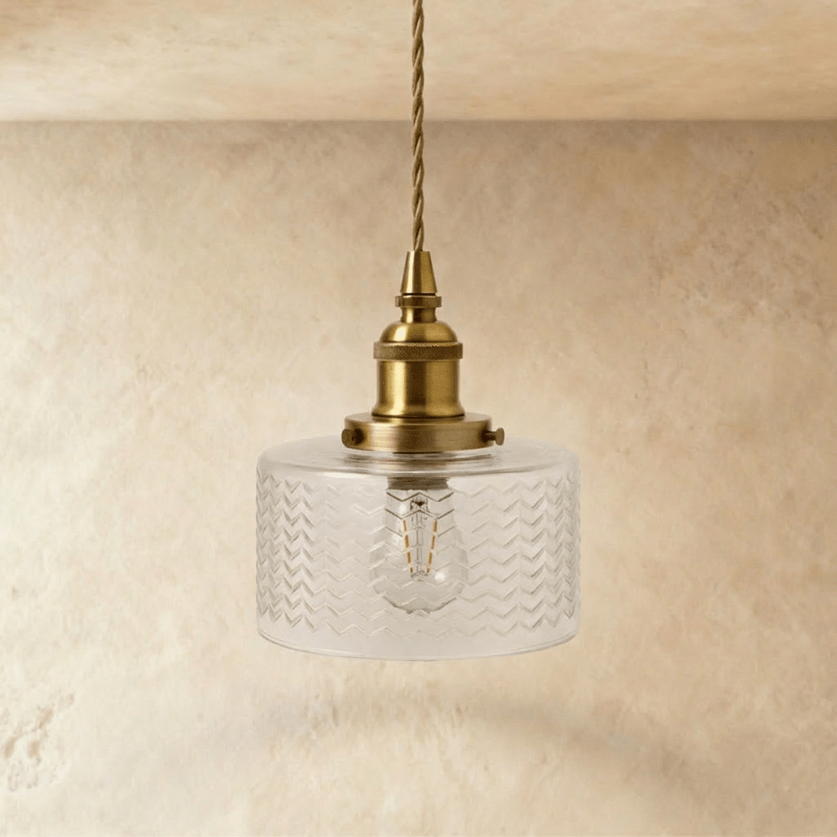 Isabel Pendant Light by Residence Supply hanging from ceiling with a sleek modern design and a warm metallic finish.
