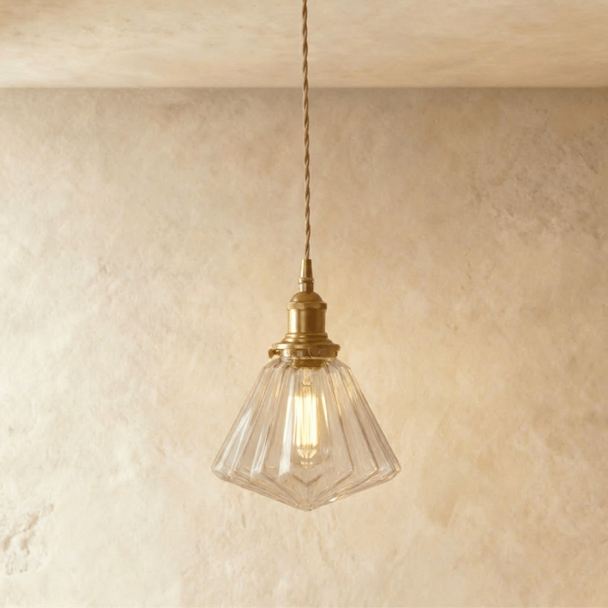 Residence Supply Isabel pendant light with a sleek metal frame and glass shade hanging from a ceiling mount.