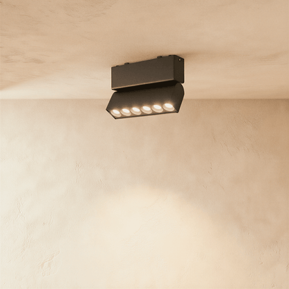 Modern Janae Track Light System by Residence Supply with adjustable spotlights mounted on a sleek black track.