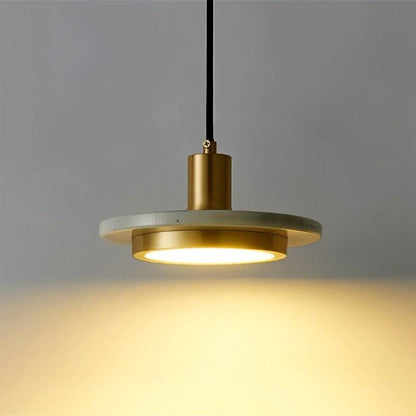 Julian Pendant Light by Residence Supply hanging from ceiling with a sleek, modern design and warm lighting in a contemporary setting.