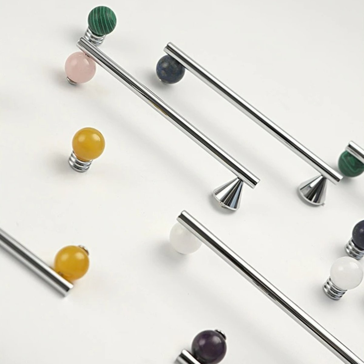 Crystal knob and pull bar from Residence Supply, designed for cabinet hardware, with clear glass finishes and metal mounting bases.