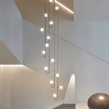 Lexto Indoor Chandelier by Residence Supply featuring a modern design with multiple hanging glass bulbs and metal accents.