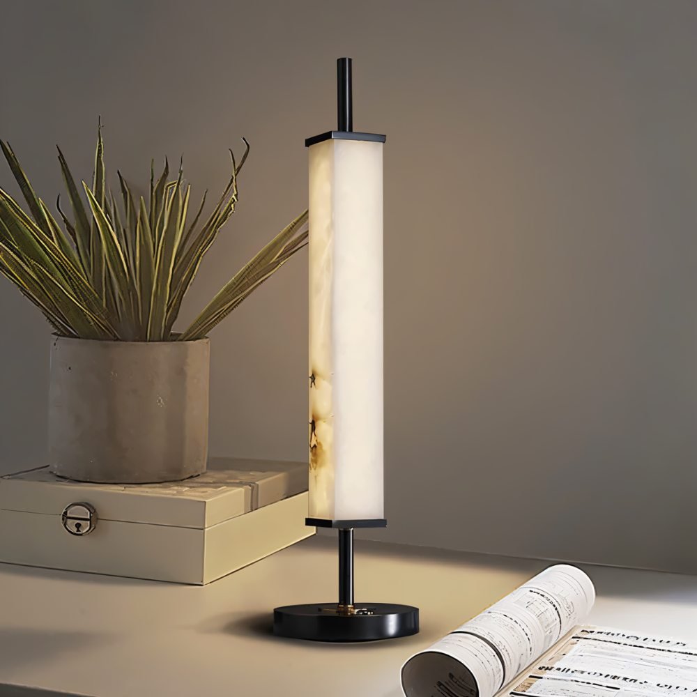 Lifang table lamp by Residence Supply featuring a modern design with a white cylindrical shade on a sleek base.