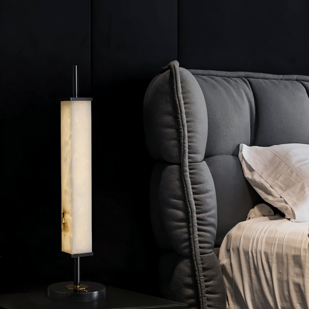 Lifang table lamp by Residence Supply with a sleek modern design and a neutral-colored lampshade on a wooden table.