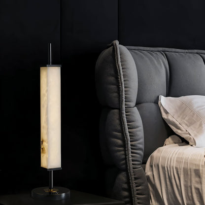 Lifang table lamp by Residence Supply with a sleek modern design and a neutral-colored lampshade on a wooden table.