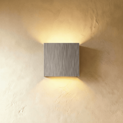 Modern Lior Wall Lamp by Residence Supply featuring sleek design with a cylindrical shade mounted on a wall bracket.