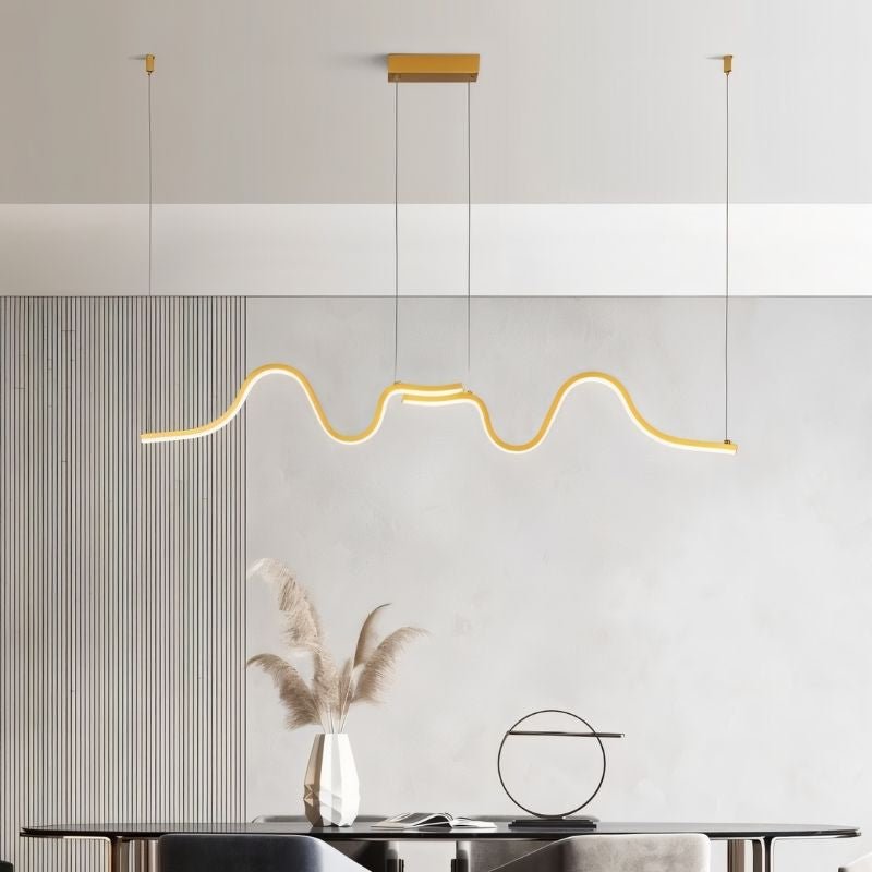 Gold wave pendant light from Residence Supply featuring a sleek, modern design with flowing, wave-inspired shape for stylish illumination.
