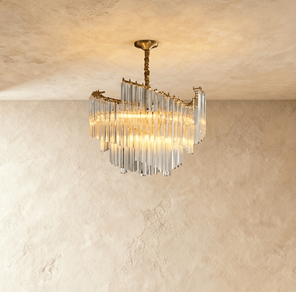Elegant Livok chandelier with multiple glass globes and brass accents, hanging from a decorative ceiling mount.