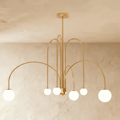 Elegant Lucille Chandelier by Residence Supply with multiple glass bulbs and intricate metal detailing.