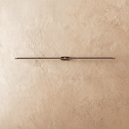 Modern Lumer Wall Lamp by Residence Supply mounted on a wall with a sleek, minimalist design and warm lighting.