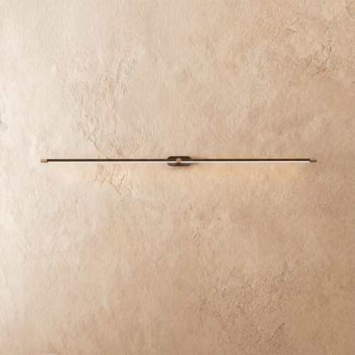 Modern Lumer Wall Lamp by Residence Supply featuring a sleek design and warm lighting, mounted on a neutral wall.