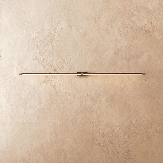 Modern Lumer Wall Lamp by Residence Supply featuring a sleek design and warm lighting, mounted on a neutral wall.