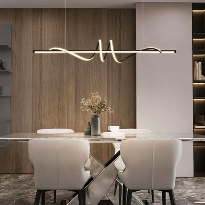 Lumexis pendant light hanging above dining table, modern design with sleek metal finish in a contemporary dining room setting.