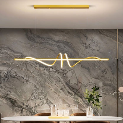 Gold Lumexis Pendant Light from Residence Supply hanging in a dining room with modern decor.