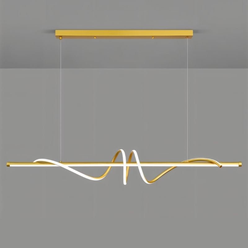 Gold Lumexis Pendant Light by Residence Supply hanging with a sleek modern design in a stylish interior setting