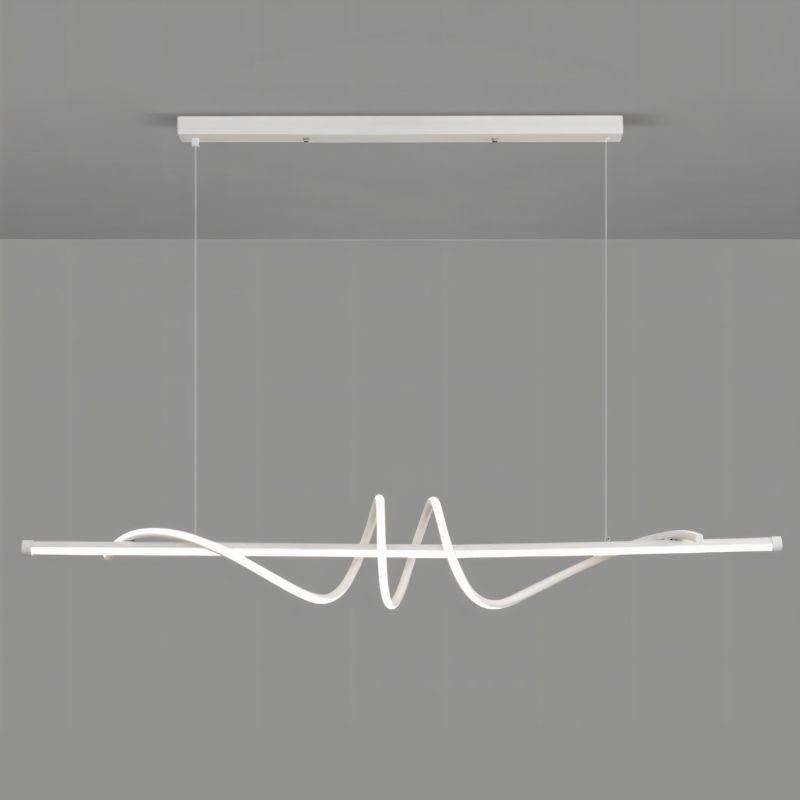 White Lumexis pendant light by Residence Supply hanging from ceiling with a modern design.