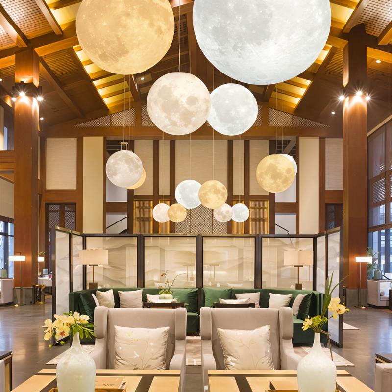 Residence Supply lunar pendant light hanging from ceiling, modern decorative lighting fixture with a moon-inspired design.