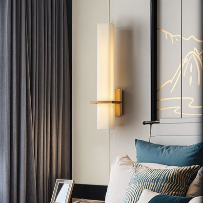 Lunara wall lamp by Residence Supply with alabaster shade and brass finish, mounted on bedroom wall for ambient lighting