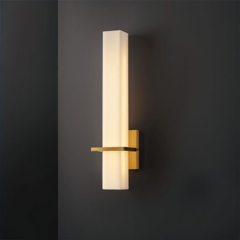 Lunara Wall Lamp by Residence Supply featuring alabaster shade and brass finish mounted on dark wall.