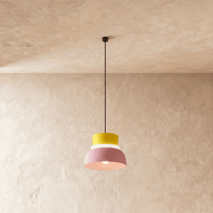 Residence Supply Macaron Pendant Light featuring a pastel-colored, rounded ceramic shade hanging from a sleek metal fixture.