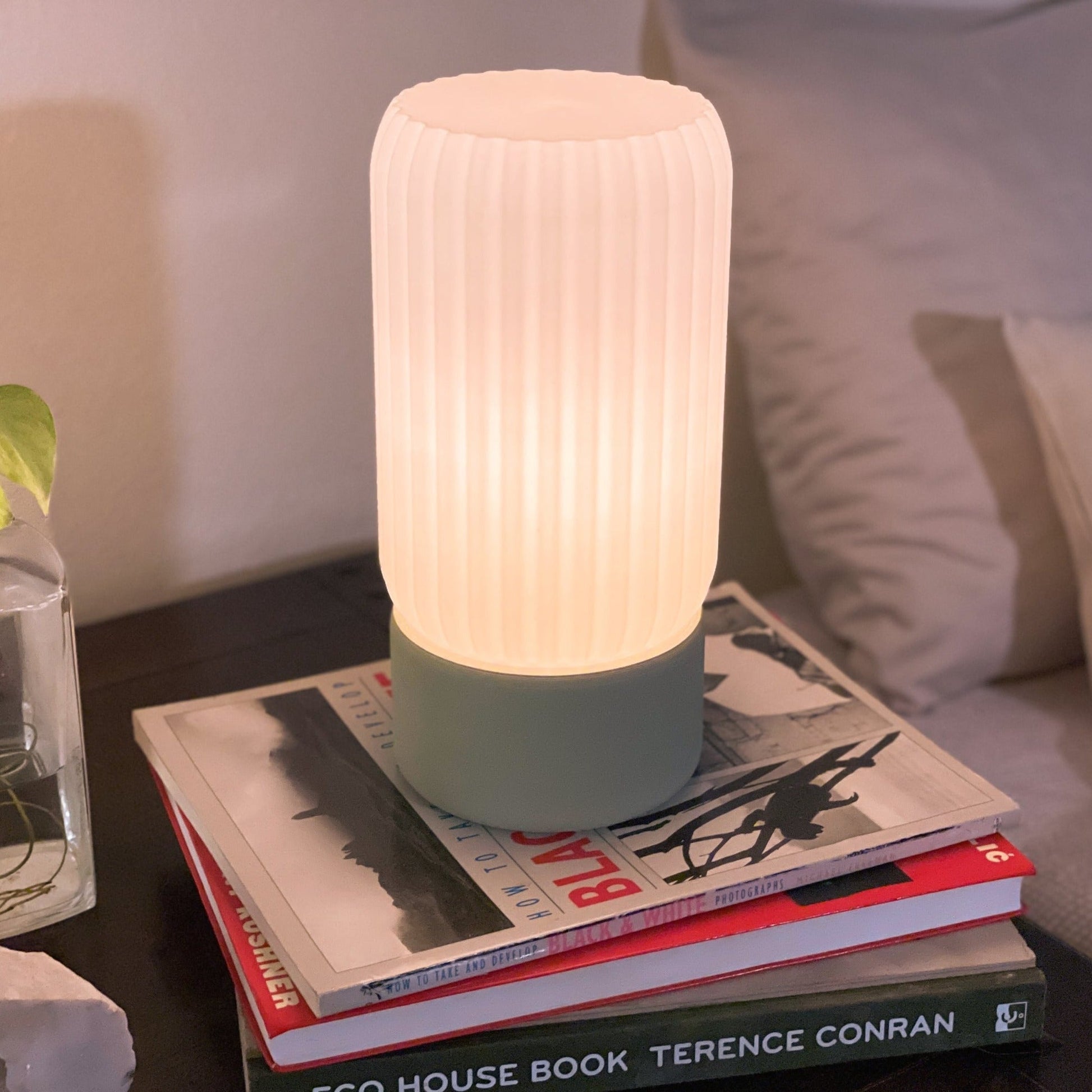 Terra Labs Milk Shade Barrel Table Lamp with a smooth, milk-colored shade and sleek barrel base on a wooden surface.