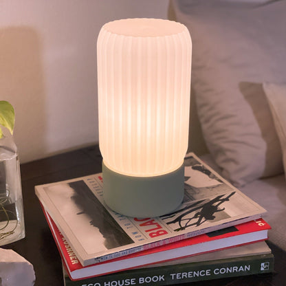 Terra Labs Milk Shade Barrel Table Lamp with a smooth, milk-colored shade and sleek barrel base on a wooden surface.