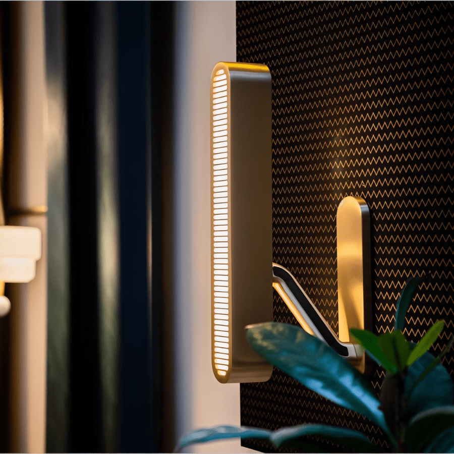 Modern Munira Wall Lamp from Residence Supply, showcasing a sleek design with a curved arm and elegant light fixture.