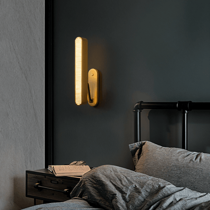 Modern Munira Wall Lamp by Residence Supply with sleek design and adjustable arm mounted on a wall for ambient lighting.