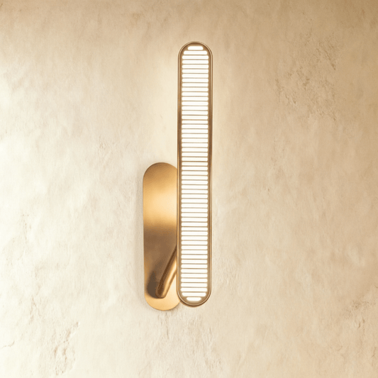 Modern Munira Wall Lamp by Residence Supply featuring a sleek, curved metal design and a warm LED light for stylish illumination.