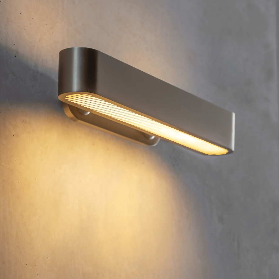 Modern Munira Wall Lamp by Residence Supply featuring sleek design and warm lighting for contemporary interior decor.