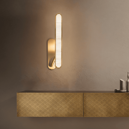 Modern Munira Wall Lamp by Residence Supply featuring a sleek metal design and soft ambient lighting.