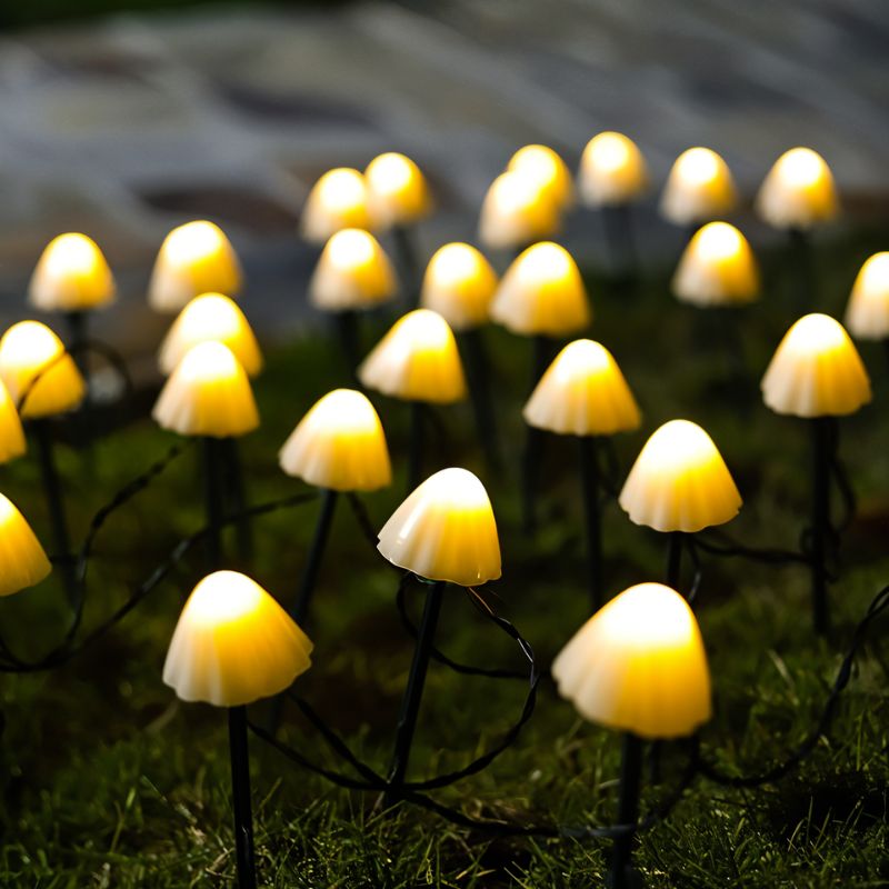 Mycena Outdoor Garden Lamp by Residence Supply illuminating a garden path with a sleek modern design and warm lighting.