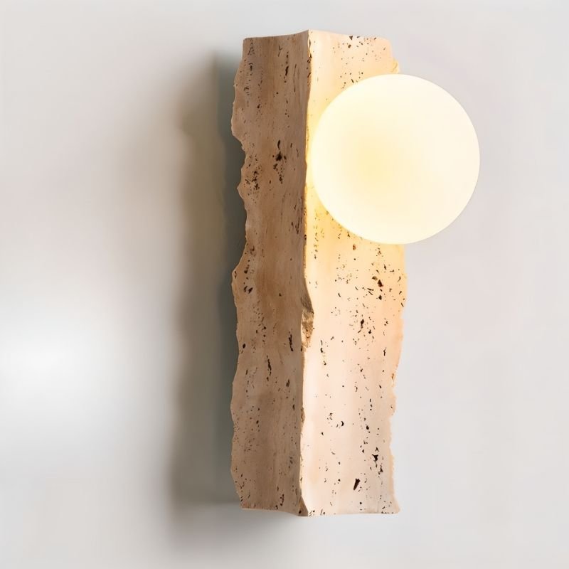Narvi wall lamp by Residence Supply featuring a travertine base and glass light shade for stylish interior lighting.