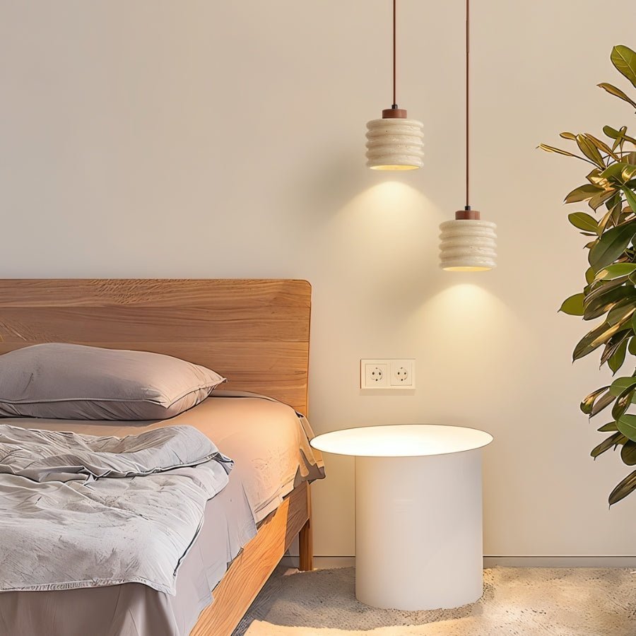 Nexon Pendant Light by Residence Supply hanging in a bedroom, featuring a travertine shade with modern design.