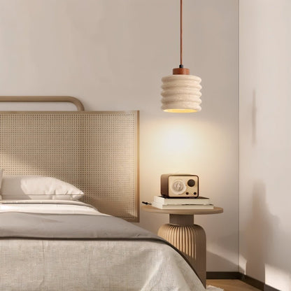 Nexon Pendant Light by Residence Supply hanging in a bedroom with a travertine finish, modern lighting fixture with a sleek design.