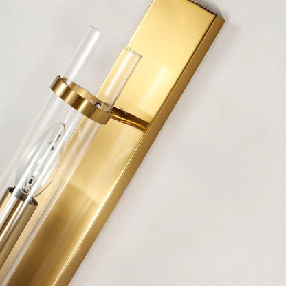 Close-up of Nexovia Wall Lamp by Residence Supply featuring a brass body and glass shade for stylish interior lighting.