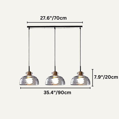 Nivkah Pendant Light by Residence Supply hanging from ceiling with a modern design and warm ambient lighting.