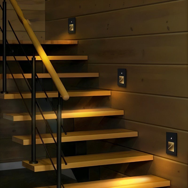 Noa Stair Light by Residence Supply, sleek modern LED step light installed on staircase wall for ambient illumination.