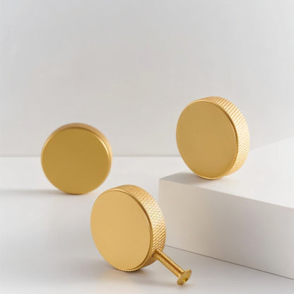 Cylindrical Noah knob with knurled modern design, made of metal, for cabinet hardware in home and garden decor.