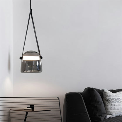 Nola Pendant Light by Residence Supply hanging from ceiling with a modern design and glass shade in a contemporary interior.