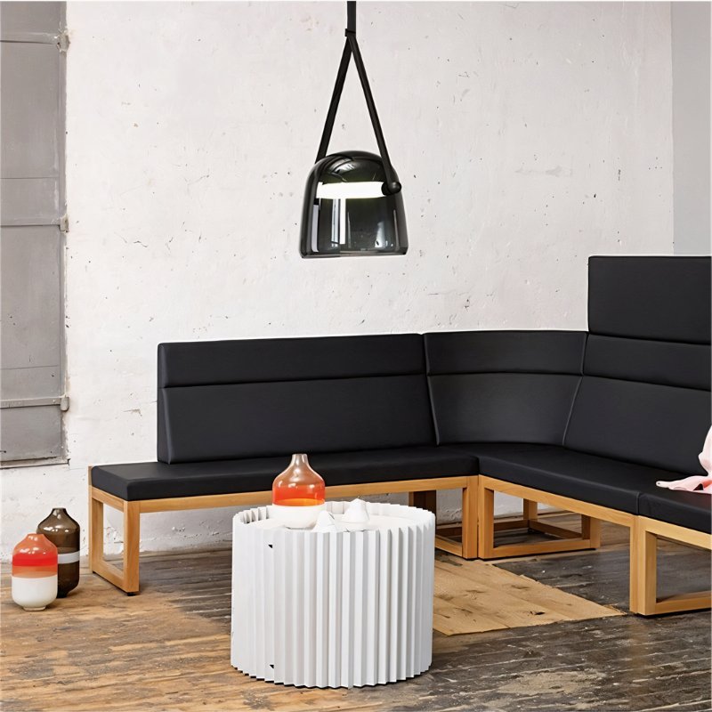 Nola pendant light by Residence Supply hanging from ceiling with a modern design and warm metallic finish.