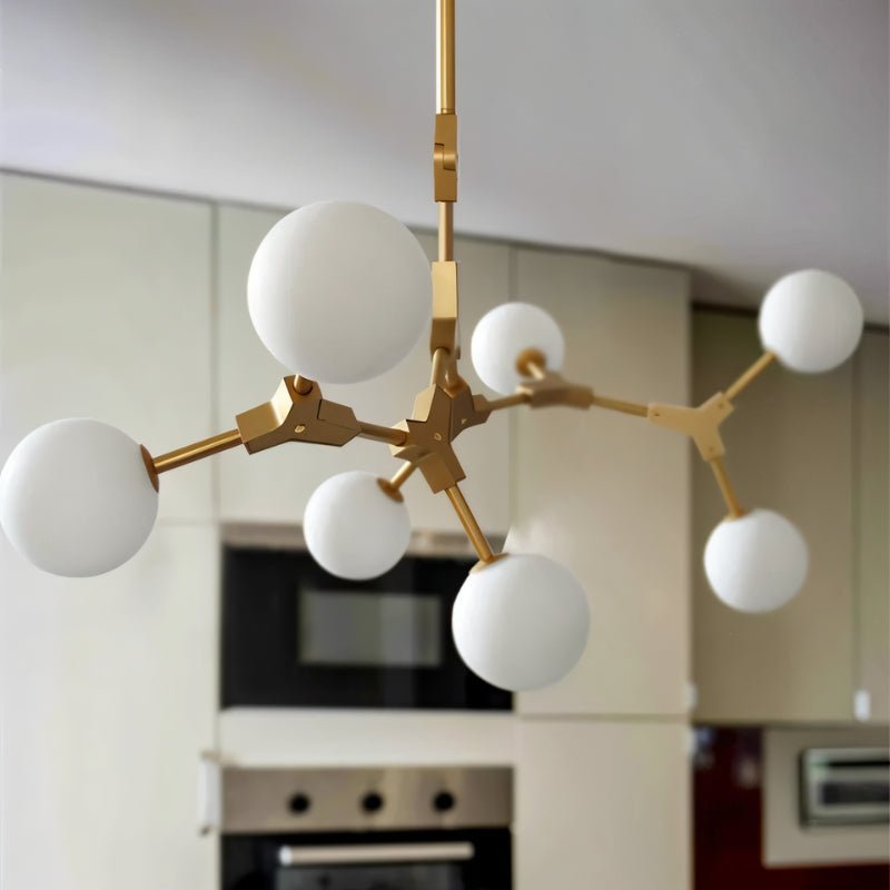 Elegant Noxira chandelier by Residence Supply featuring multiple hanging glass orbs and a sleek metal frame.