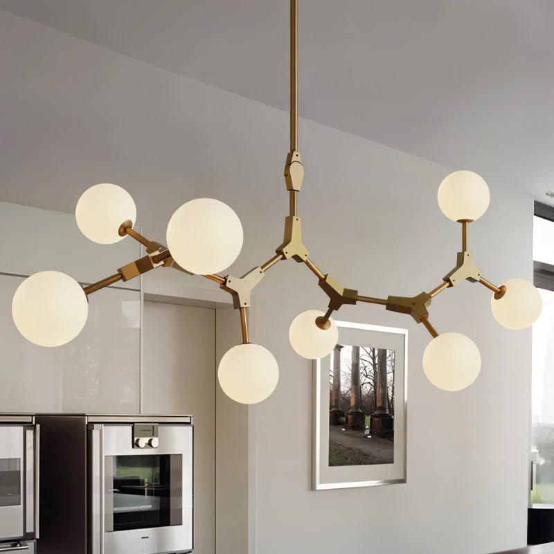 Elegant Noxira chandelier by Residence Supply with intricate metalwork and multiple light bulbs, hanging from a ceiling fixture.