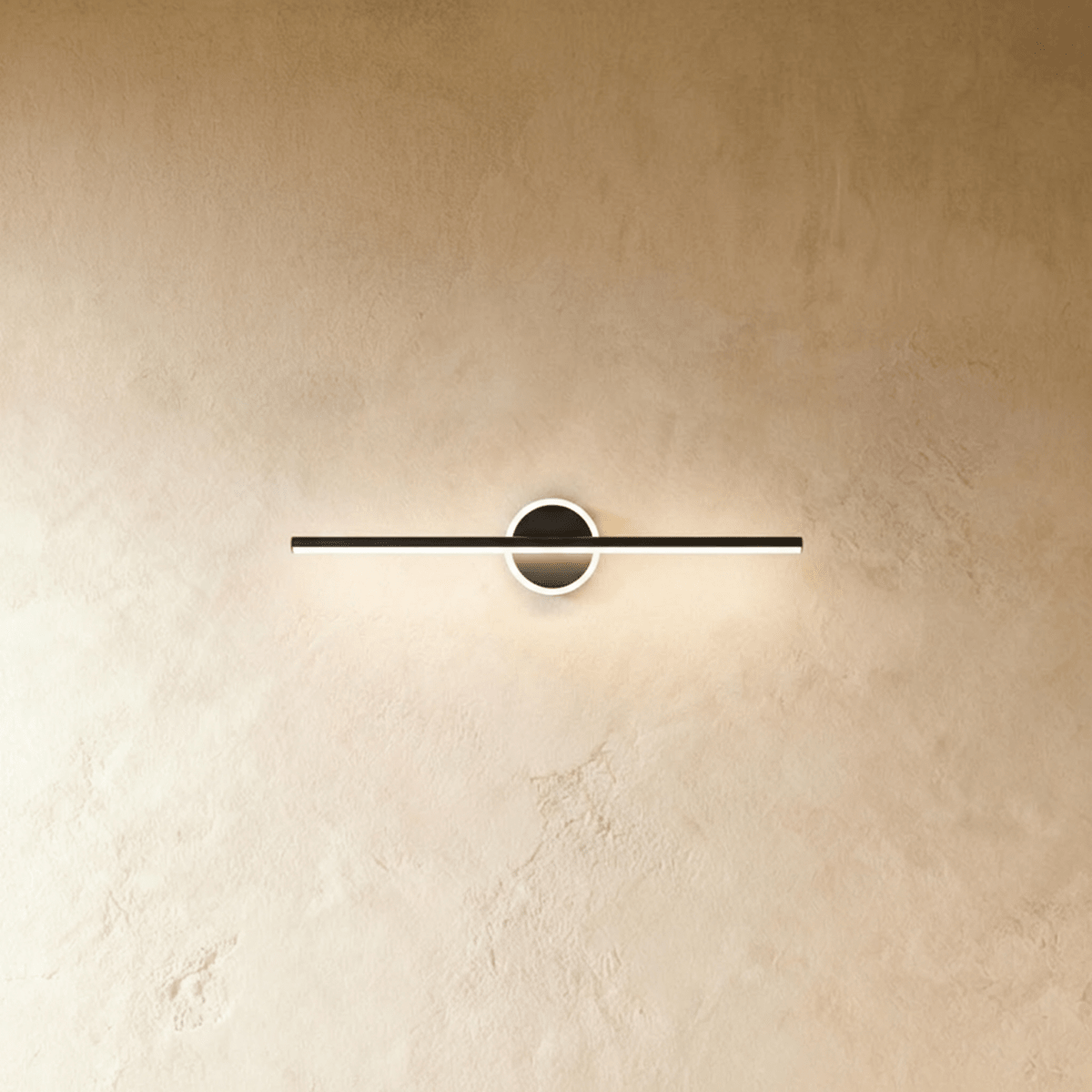 Nyxtra Wall Lamp by Residence Supply mounted on a wall with a modern design, featuring a sleek metal finish and ambient lighting.