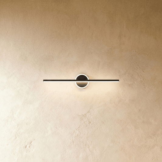 Nyxtra Wall Lamp by Residence Supply mounted on a wall with a modern design, featuring a sleek metal finish and ambient lighting.