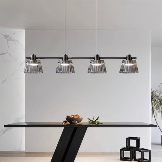 Modern Odis chandelier from Residence Supply hanging above a dining table in a contemporary dining room.