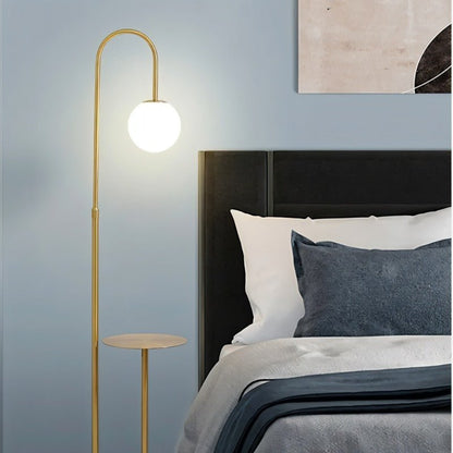 Okul floor lamp with integrated smart side table by Residence Supply, featuring sleek design and modern lighting for living rooms.