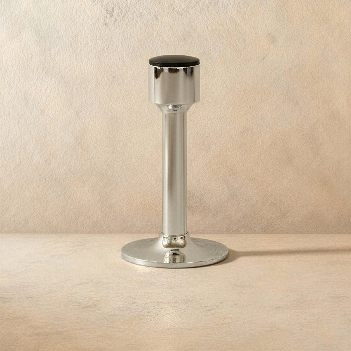 Open-box Residence Supply Pesu door stop in brass finish, mounted on a door to prevent swinging. Home and garden hardware.